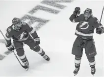  ?? DAN HAMILTON • USA TODAY SPORTS ?? Tampa Bay Lightning centre Brayden Point, right, celebrates after scoring the game-winning goal against the Columbus Blue Jackets in the fifth overtime in Game 1 of the first round of the 2020 Stanley Cup Playoffs at Scotiabank Arena in Toronto.