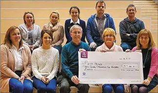  ??  ?? Marie Peelo from Pieta House (front, second from right) presents the cheque to the committee.