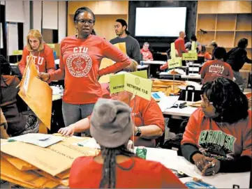  ?? E. JASON WAMBSGANS/CHICAGO TRIBUNE ?? Chicago Teachers Union staff members count votes on the tentative contract agreement at CTU Center.