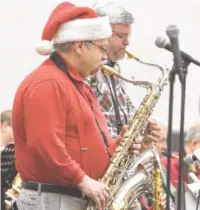  ?? STAFF FILE PHOTO ?? Mike LaRoche, foreground, of Sweet Georgia Sound big band plays at a previous Holiday Market. The big band is among local acts playing the Holiday Market this month.