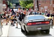  ?? ASSOCIATED PRESS ?? A VEHICLE DRIVES into a group of protesters demonstrat­ing against a white nationalis­t rally in Charlottes­ville, Va., Saturday.