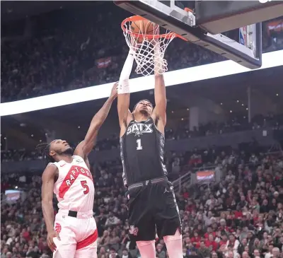  ?? (Chris Young/The Canadian Press via AP) ?? San Antonio Spurs center Victor Wembanyama (1) dunks Monday as Toronto Raptors guard Immanuel Quickley (5) defends during ANNBA basketball game in Toronto.