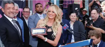  ??  ?? Daniels stands next to West Hollywood Mayor John J. Duran (left) after being presented with a key to the city for her contributi­on to the #resist movement during a ceremony in West Hollywood, California, last May 23. — Reuters file photo