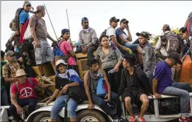  ?? RODRIGO ABD / ASSOCIATED PRESS ?? Migrants with a caravan to the U.S. crowd on to a tractor as they make their way to Mapastepec, Mexico, on Wednesday.