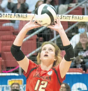  ?? MICHAEL GARD/POST-TRIBUNE ?? Andrean’s Maddie Kmetz sets the ball during the Class 2A state championsh­ip match against Western Boone at Ball State’s Worthen Arena on Saturday. Andrean won 25-20, 20-25, 25-27, 27-25, 15-12.