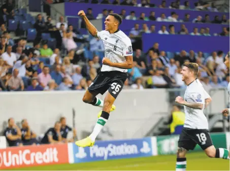  ?? Michael Probst / Associated Press ?? Liverpool’s Trent Alexander-Arnold gets some air time celebratin­g his team’s opening goal against Hoffenheim.