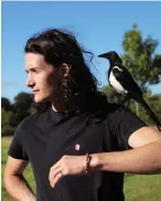  ??  ?? Charlie Gilmour and his rescued magpie