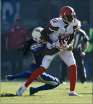  ?? KELVIN KUO — ASSOCIATED PRESS ?? Josh Gordon is tackled by the Chargers’ Tre Boston during the first half on Dec. 3 in Carson, Calif.