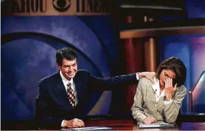  ?? Houston Chronicle file ?? KHOU-TV news anchor Sylvan Rodriguez comforts co-anchor Lisa Foronda after telling viewers he has cancer and will be leaving the station for several months of treatment in 1999.