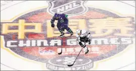  ?? Lintao Zhang Getty Images ?? VANCOUVER’S Brandon Sutter, left, chases the Kings’ Tyler Toffoli during a game in Beijing in 2017. The NHL is trying to grow its brand in China.