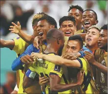  ?? *REUTERS ?? Ecuador’s Enner Valencia is mobbed by teammates after netting the team’s second goal in a 2-0 win over Qatar on Sunday.