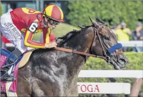  ?? Skip Dickstein / Special to the Times Union ?? Mckinzie and Mike Smith win the 2019 Whitney at Saratoga. Smith rides elsewhere and won’t be at the Spa this year due to NYRA precaution­s.