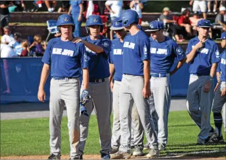  ?? AUSTIN HERTZOG - DIGITAL FIRST MEDIA ?? Above, Exeter’s Chris Smith, left, is consoled teammate Nate Serba, second from left, as the Blue Jays line up for handshakes after their season-ending defeat to Norchester Sunday at West Lawn.