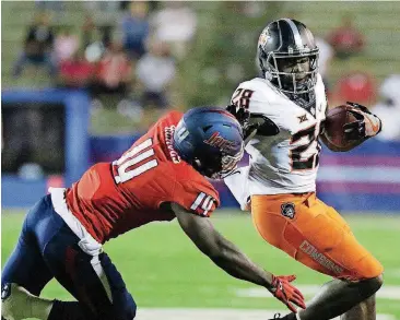  ?? [AP PHOTO] ?? Oklahoma State moved up two spots in the Associated Press and coaches’ polls after James Washington (28) and the Cowboys defeated South Alabama 44-7 on Friday night.