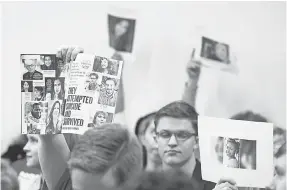  ?? STEVE HELBER/ AP ?? Supporters of gun laws hold photos of gun violence victims during the meeting of the Senate Judiciary committee at the Capitol in Richmond, Va., on Monday.