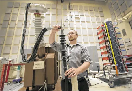  ?? PHOTOS / AMERICAN-STATESMAN
RALPH BARRERA ?? Sean Davis works in 3M’s Electrical Markets Division, testing products and how they stand up to severe lightning and electrical current. He is testing terminatio­n splices to see if they can pass a certain voltage impulse. 3M in Austin is a product...