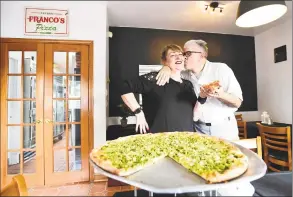  ?? Peter Hvizdak / Hearst Connecticu­t Media ?? Angela Franco, owner of Franco’s Pizza, left, and her pizzamakin­g husband, Franco, at their new location on 11 Berwyn St. in Milford. The couple have been married for 32 years and in business as Franco's Pizza since 1991.