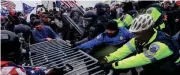  ?? ?? Insurrecti­ons loyal to former President Donald Trump tried to break through a police barrier on Jan. 6, 2021, at the Capitol in Washington. The Department of Justice is prosecutin­g those who violently stormed the Capitol.