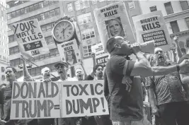  ?? DREW ANGERER/GETTY IMAGES ?? Protesters rally outside of Trump Tower in New York in opposition to Donald Trump.