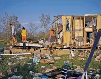  ?? JOHN LOCHER/ASSOCIATED PRESS ?? Aiden Locobon, left, and Rogelio Paredes look through the remnants of their home destroyed by Hurricane Ida in Dulac, La. Students, who were back in class after a year and a half of COVID-19 disruption­s, are now missing school again after the storm.