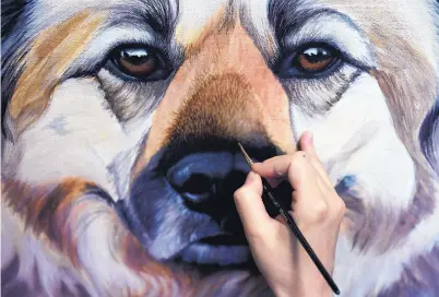  ?? MATT MCCLAIN/THE WASHINGTON POST ?? Erica Eriksdotte­r works on a painting of a dog named Ernie at her home studio in Reston, Virginia.