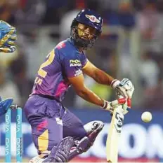  ?? AFP ?? Rising Pune Supergiant Rahul Tripathi guides a shot down to the thirdman against Mumbai Indians.