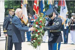  ?? SAUL LOEB/GETTY-AFP ?? President Joe Biden participat­es in a wreath-laying ceremony Monday at Arlington National Cemetery.