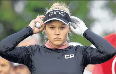  ?? CP PHOTO ?? Brooke Henderson adjusts her visor at the first hole during the 2017 CP Women’s Open of the LPGA Tour in Ottawa.