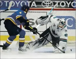  ??  ?? Goaltender Devan Dubnyk, making his Sharks debut, defends against Carl Gunnarsson of the St. Louis Blues during the first period Monday night.