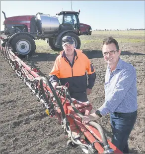  ??  ?? GOING IN: Farmer Steve Ruwoldt, left, and farm manager Brian Matuschka prepare for sowing as part of Longerenon­g College’s DATA Farm project. Picture: PAUL CARRACHER