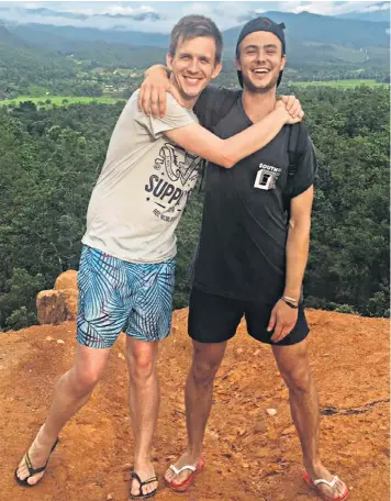  ??  ?? Paul Mcclean and Chris Baller hug while posing on top of a Sri Lankan mountain. Mr Baller posted the image in tribute to his friend