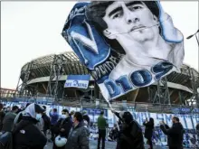  ?? DRO GAROFALO/LAPRESSE VIA AP
ALESSAN- ?? A fan waves a flag with the portrait of soccer legend Diego Armando Maradonain front of the San Paolo stadium in Naples, Italy, Thursday. Maradona died Wednesday, in Buenos Aires.