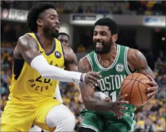  ?? MICHAEL CONROY — THE ASSOCIATED PRESS ?? Boston Celtics guard Kyrie Irving, right, is fouled by Indiana Pacers guard Wesley Matthews, left, during the first half of Game 4.