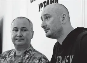  ??  ?? Russian journalist Arkady Babchenko, right, and Vasily Gritsak, head of the Ukrainian Security Service, appear at a news conference Wednesday in Kiev. Babchenko turned up less than 24 hours after police reported he had been shot and killed at his Kiev apartment building.