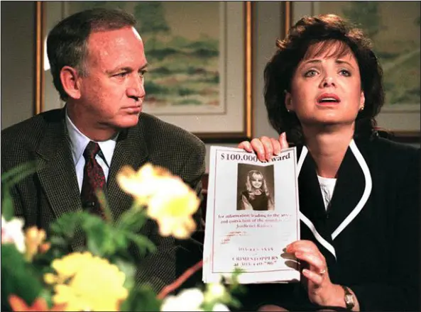  ?? CAMERA FILE PHOTO ?? John Ramsey looks on as his wife, Patsy, holds an advertisem­ent promising a reward for informatio­n leading to the arrest and conviction of the murderer of their 6-year-old daughter, Jonbenet, during an interview May 1, 1997, in Boulder.