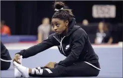  ?? CHARLIE RIEDEL — THE ASSOCIATED PRESS ?? Simone Biles stretches during practice for the U.S. Gymnastics Championsh­ips on Aug. 7 in Kansas City, Mo.