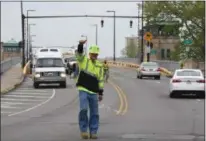 ?? ERIC BONZAR — THE MORNING JOURNAL ?? James Peavey, of Richfield-based American Roadway Logistics Inc., gives a thumbs-up May 21, 2018, as he and his fellow crew members mark out lanes on the Charles Berry Bascule Bridge.
