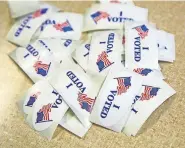  ?? [THE OKLAHOMAN ARCHIVES] ?? Voting stickers on a table in the polling place at Central Presbyteri­an Church. The COVID-19 pandemic has affected the way candidates campaign for office.