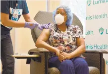  ?? RACHAEL PACELLA/ CAPITAL GAZETTE ?? Registered respirator­y therapist Tywana Jackson receives a COVID-19 vaccine Monday at Anne Arundel Medical Center.