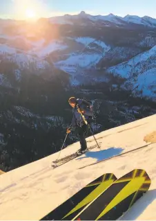  ??  ?? Zach Milligan, top, gingerly makes his way down Half Dome. Above, Jason Torlano captures an image of his ski tips, along with Milligan and a sweeping view of Yosemite Valley.