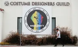  ?? Photograph: Mario Anzuoni/Reuters ?? A banner hung in support of the the Internatio­nal Alliance of Theatrical Stage Employees (IATSE) outside the Costume Designers Guild offices in Burbank, California.