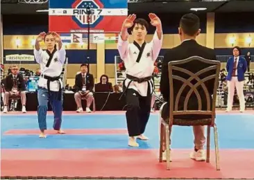  ??  ?? In sync: Yong Jin Kun (right) and Yap Khim Wen en route to winning gold in poomsae in the US Open in Las Vegas, Nevada.