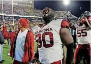  ?? [AP PHOTO] ?? OU nose tackle Neville Gallimore celebrates the victory over West Virginia.