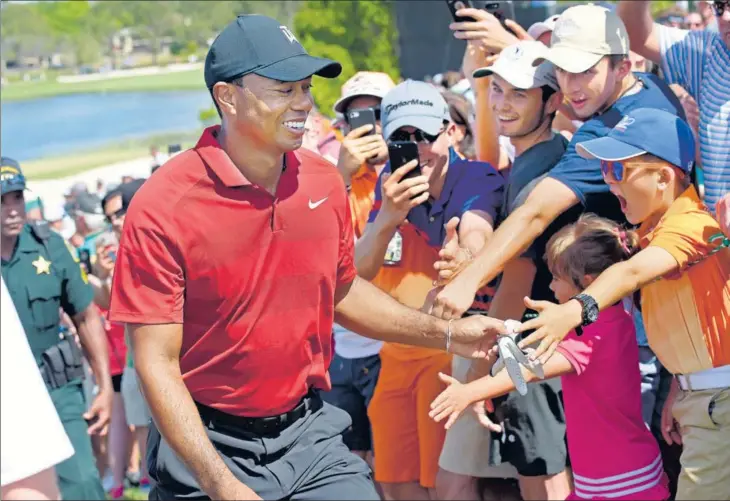  ??  ?? Fans reaching out for Tiger Woods have found reciprocat­ion of late. The face of world golf, who has had a great year winning his 15th Major and a record equalling 82nd PGA Tour title, says he now lives in the present and enjoys the moment.