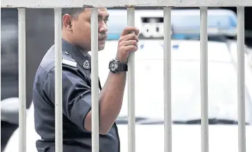  ?? AFP ?? A Malaysian Police personnel stands guard at the forensics wing of the Hospital Kuala Lumpur in the Malaysian capital yesterday, where the body of Kim Jong-nam is being kept.