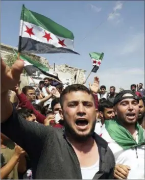  ?? COURTESY OF MUSTAFA ALABDULLAH VIA AP ?? This image courtesy of Mustafa Alabdullah, an activist and resident of Idlib, shows protesters chanting as they holding Syrian revolution flags, in Harim, a town in Idlib province, Syria, Friday.