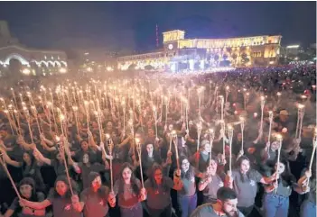  ?? VAHRAM BAGHDASARY­AN/PHOTOLURE ?? People take part in a torchlight procession Saturday in Yerevan, Armenia, to mark the 107th anniversar­y of the start of atrocities against Armenian Christians by Ottoman Empire forces that lasted well into 1916. An estimated 2 million Armenians were deported with 1.5 million killed. Turkey has long denied that it took part in genocide.