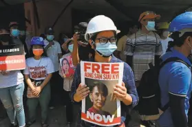  ?? AFP / Getty Images ?? A protester holds a placard calling for the release of ousted civilian leader Aung San Suu Kyi during a demonstrat­ion against the military coup in Yangon.