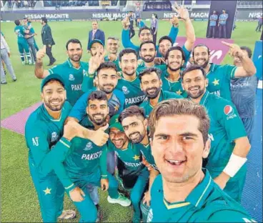  ?? ANI ?? Pakistan's Shaheen Shah Afridi (R) takes a selfie with his teammates after beating India in Dubai on Sunday.