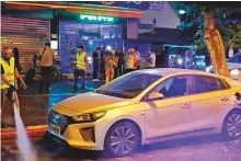  ?? AFP ?? ■ A municipal worker cleans a street in the southern Israeli coastal city of Ashdod on Tuesday night, following a rocket attack fired from the Gaza Strip.